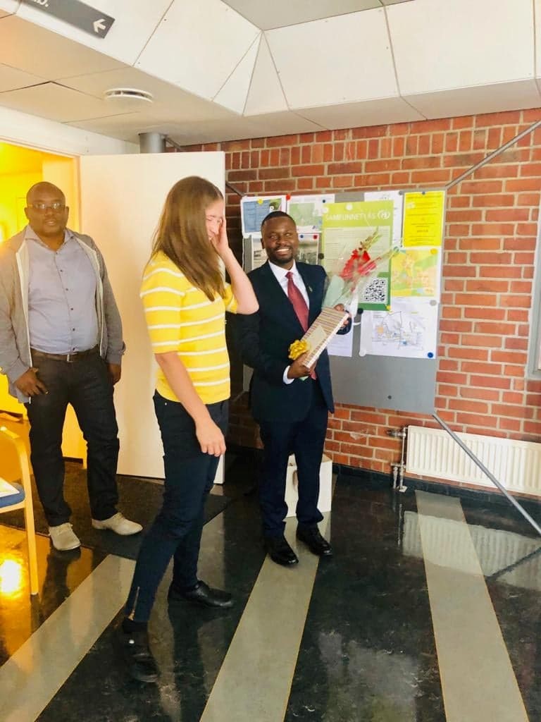 Dr. Nyamoga receiving a Gift from one of the Co Supervisor Associate Professor Hanne K. Sjølie